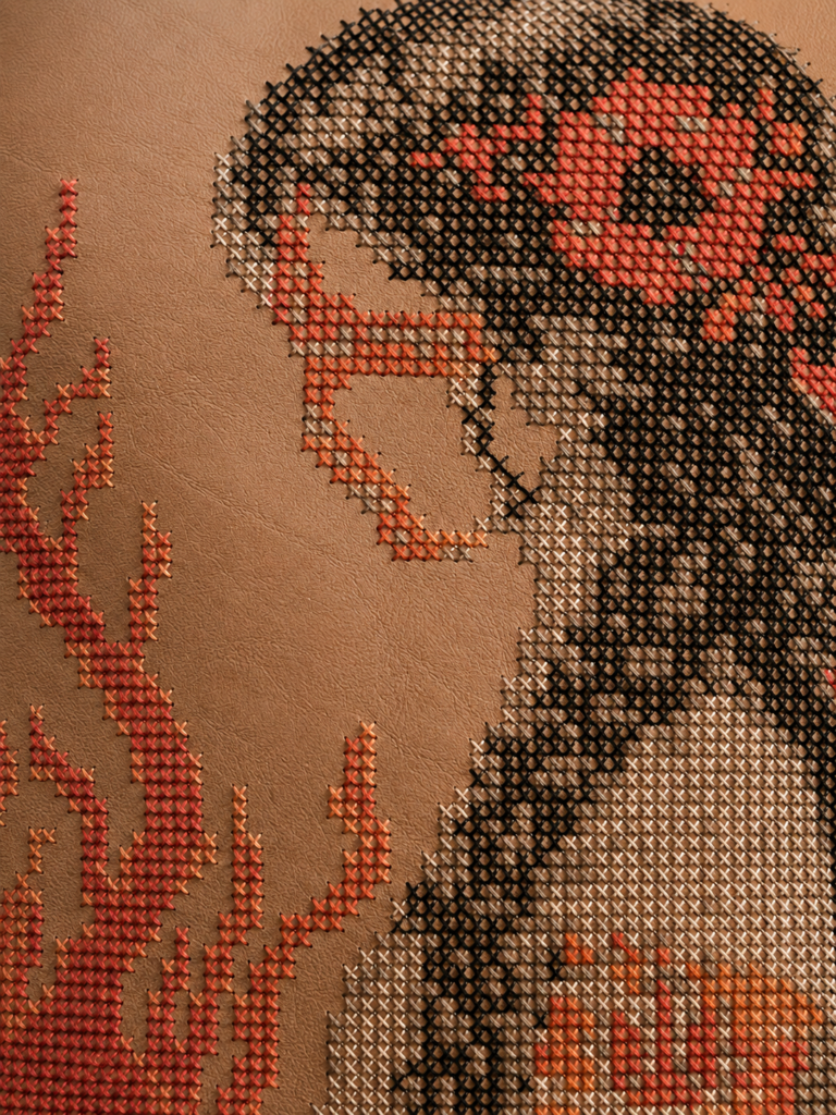 Close-up of encoded hand embroidery on leather by MIARUNA